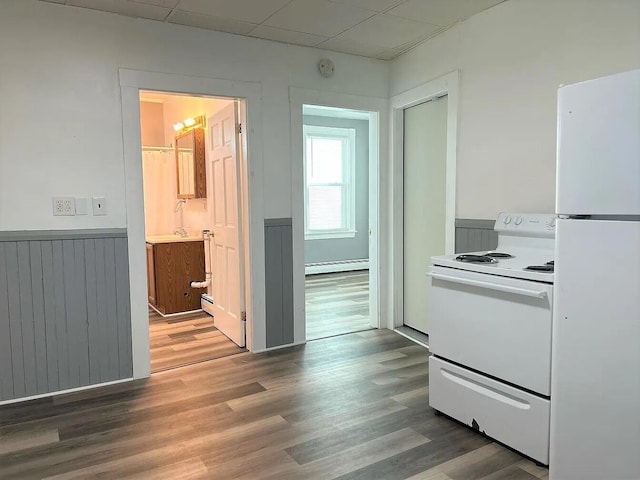 kitchen featuring a paneled ceiling, wood-type flooring, white appliances, and baseboard heating