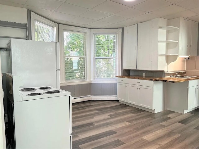 kitchen with white cabinets, white appliances, plenty of natural light, and sink