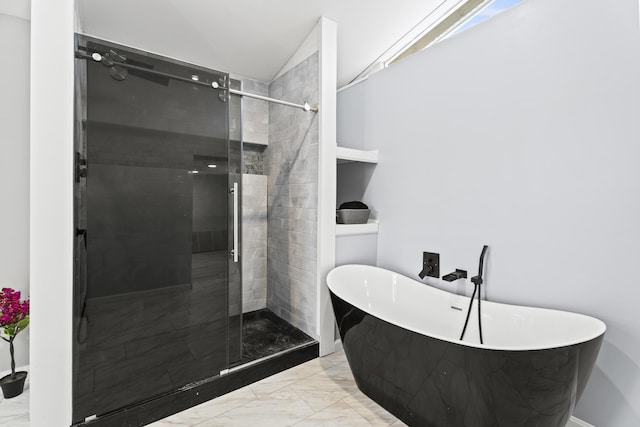 bathroom featuring lofted ceiling and independent shower and bath