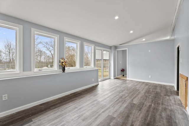 interior space featuring dark wood-type flooring and vaulted ceiling