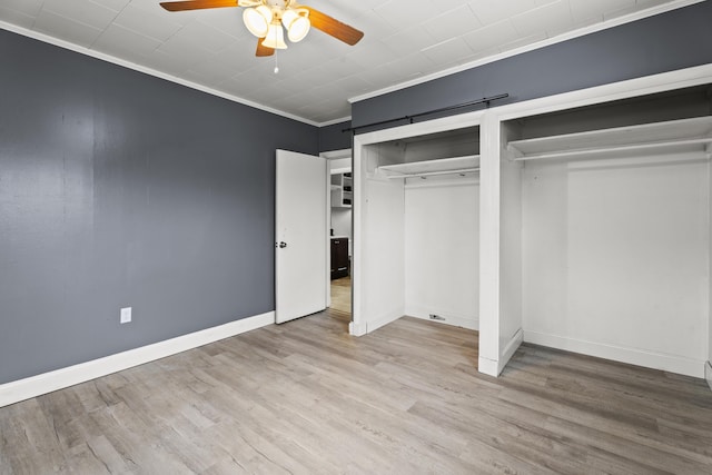 unfurnished bedroom featuring hardwood / wood-style flooring, ceiling fan, and ornamental molding