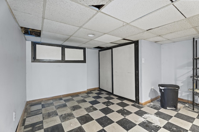 basement featuring a paneled ceiling