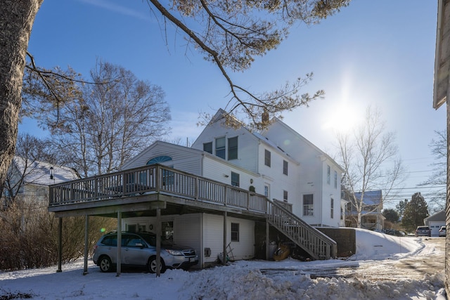 view of snow covered exterior with a wooden deck