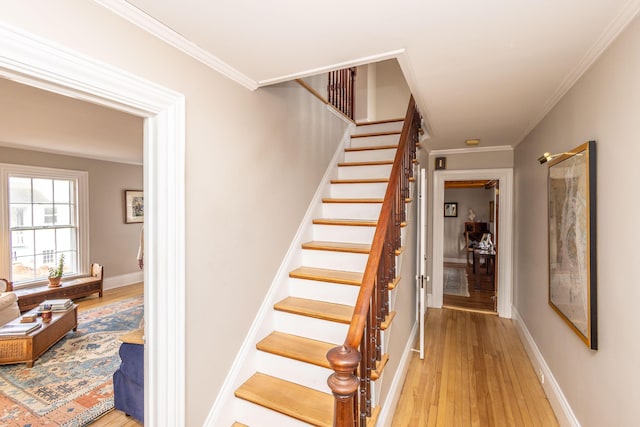 stairway featuring hardwood / wood-style flooring and ornamental molding