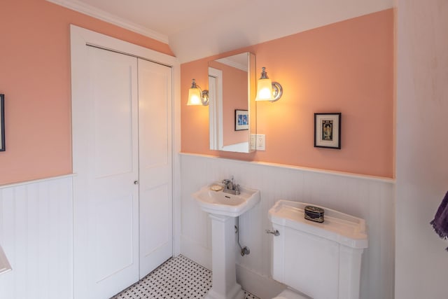 bathroom with crown molding and toilet