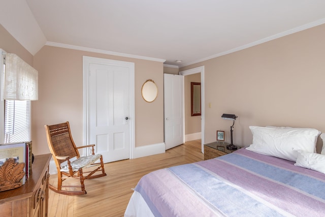 bedroom featuring lofted ceiling, hardwood / wood-style flooring, and crown molding