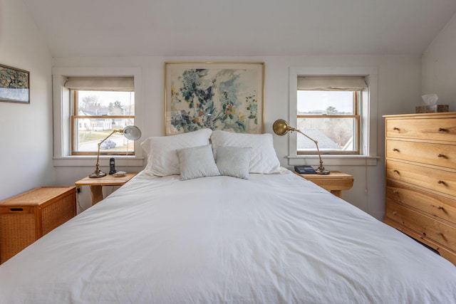 bedroom with multiple windows and lofted ceiling