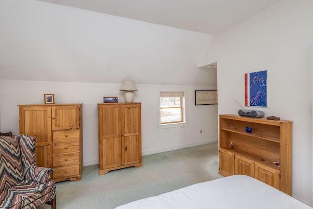 bedroom with light carpet and lofted ceiling