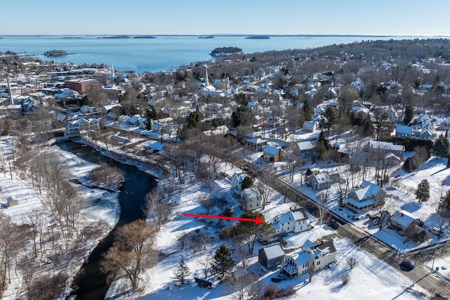 snowy aerial view featuring a water view