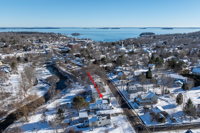 snowy aerial view with a water view