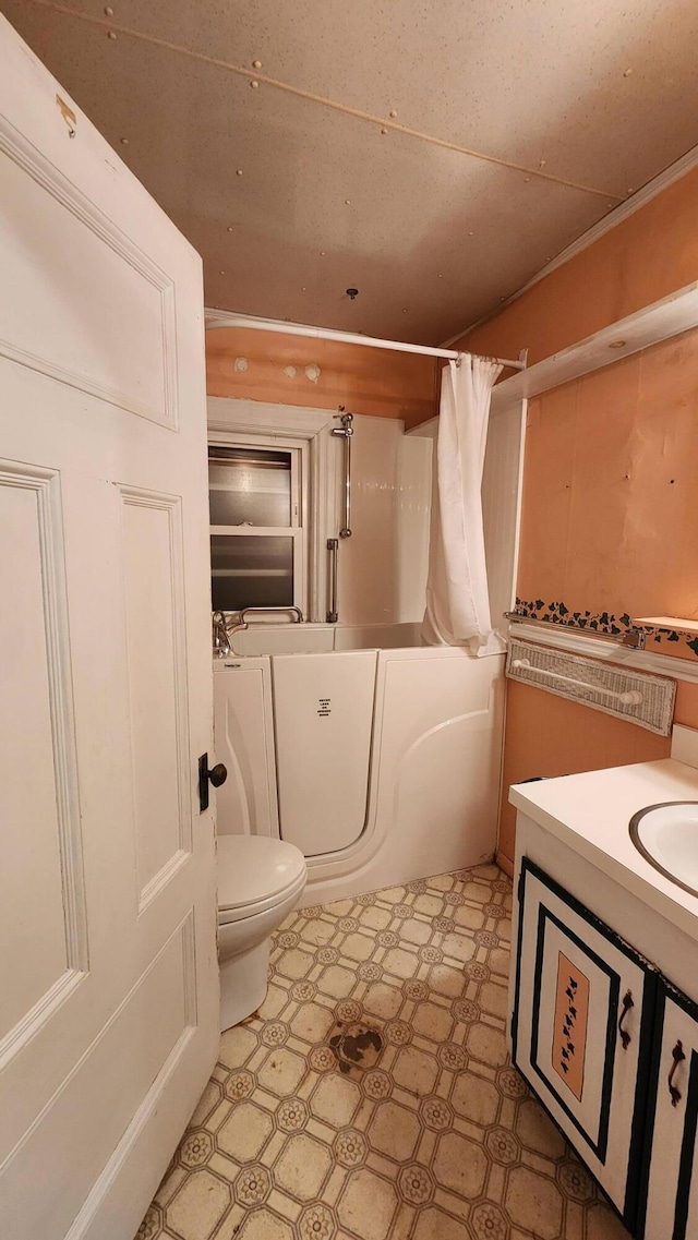 full bathroom featuring vanity, shower / tub combo, and toilet