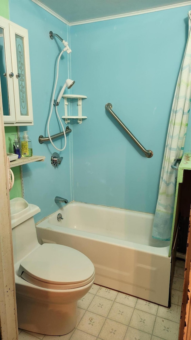 bathroom featuring shower / tub combo and toilet