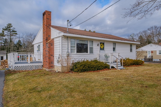 view of front of property with a front yard and a deck