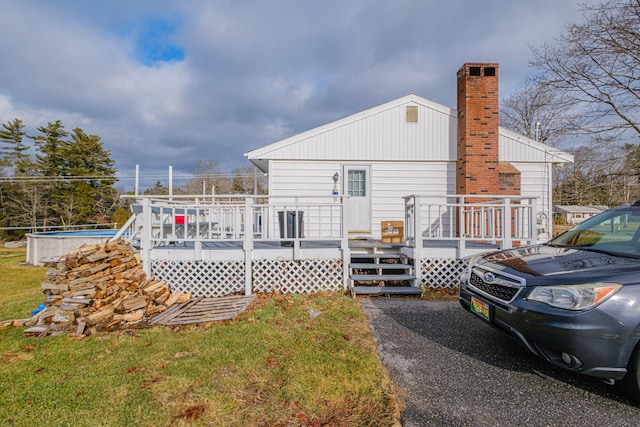 rear view of property featuring a deck