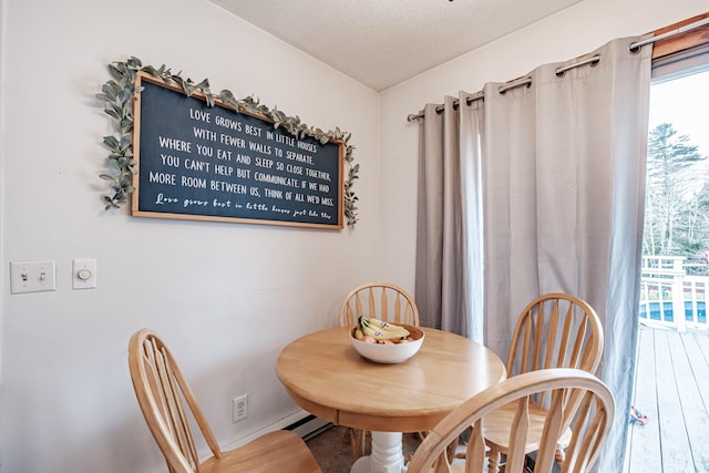 dining space with a textured ceiling