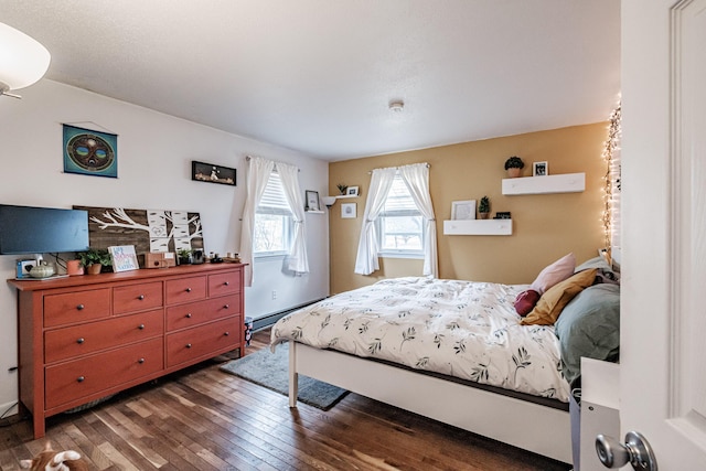 bedroom featuring a baseboard radiator and dark hardwood / wood-style floors