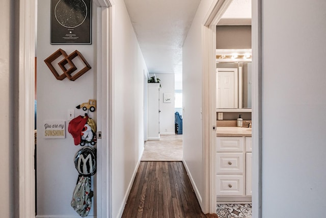 corridor with hardwood / wood-style floors