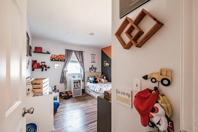 bedroom with dark hardwood / wood-style flooring