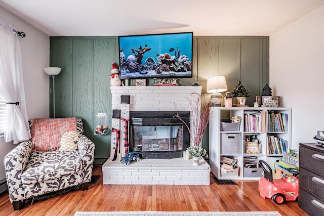 living room featuring a fireplace and light wood-type flooring