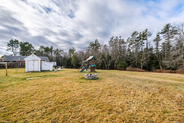 view of yard with a playground and a shed