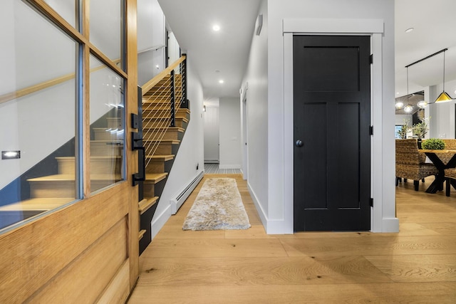 interior space with light hardwood / wood-style floors and a baseboard heating unit