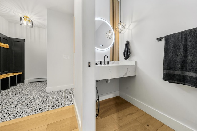 bathroom featuring hardwood / wood-style floors and a baseboard radiator