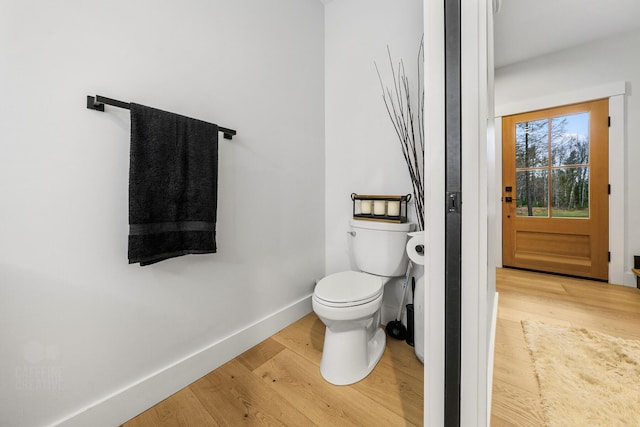 bathroom with wood-type flooring and toilet