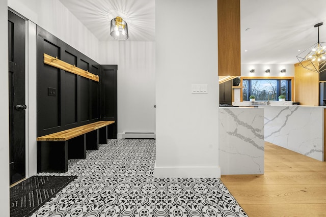 mudroom featuring a notable chandelier and baseboard heating