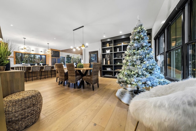 dining room with an inviting chandelier and light hardwood / wood-style flooring