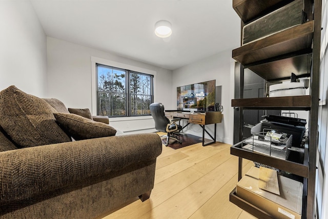 office area with hardwood / wood-style flooring and a baseboard radiator