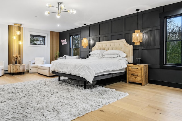 bedroom featuring a chandelier and light wood-type flooring