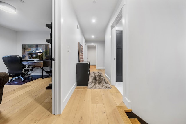 corridor with hardwood / wood-style floors