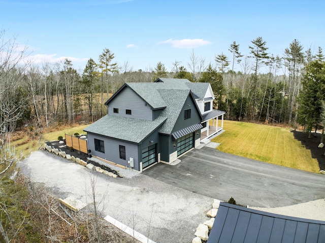 view of side of property featuring a yard and a garage