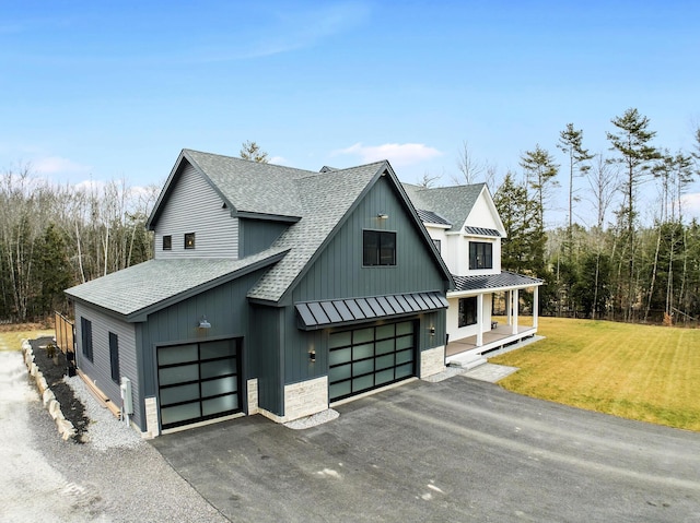 modern inspired farmhouse with covered porch and a front lawn