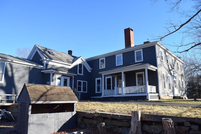 rear view of property with a porch