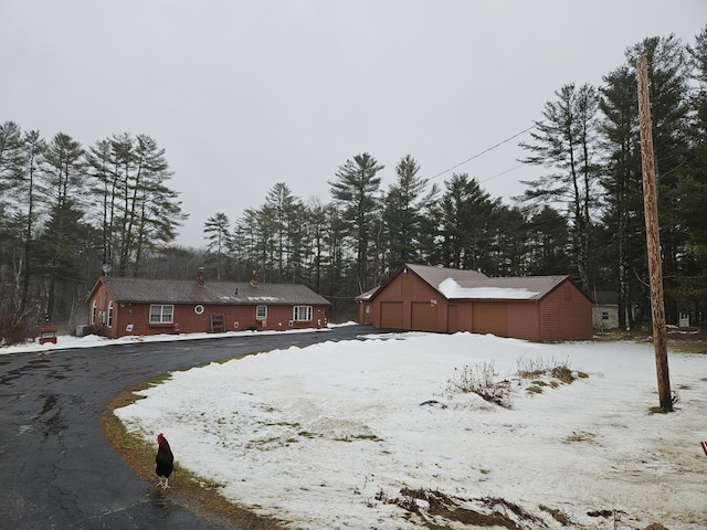 yard covered in snow featuring a garage