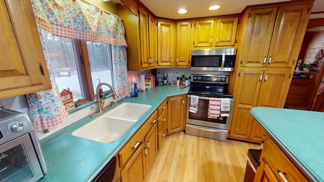893 Horseback Rd, Levant, ME 04456 - kitchen featuring stainless steel appliances, light wood-type flooring, brown cabinetry, backsplash, and recessed lighting