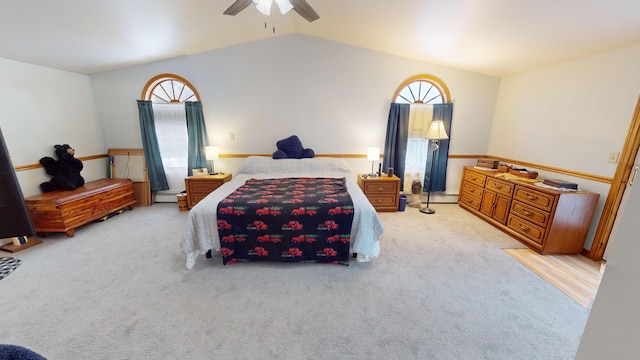 carpeted bedroom with ceiling fan and lofted ceiling