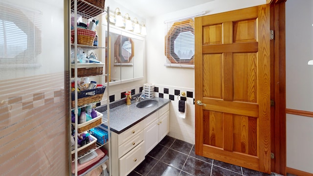 893 Horseback Rd, Levant, ME 04456 - bathroom featuring vanity, tile patterned flooring, tile walls, and wainscoting