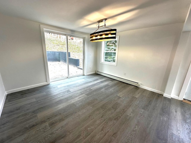 unfurnished dining area with dark wood-type flooring and a baseboard heating unit