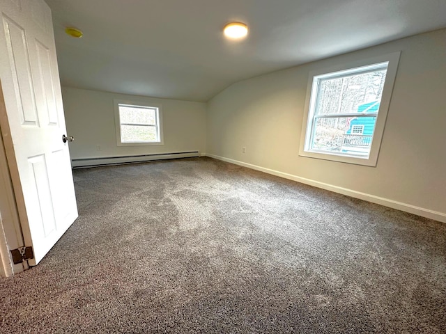 bonus room featuring a baseboard radiator, vaulted ceiling, and dark carpet