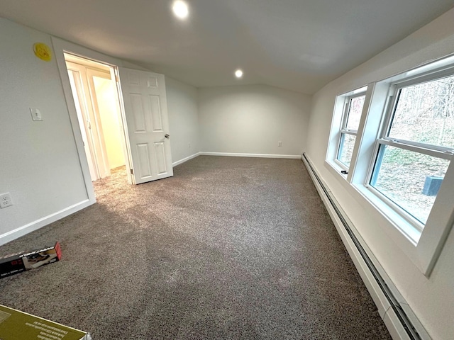 interior space with carpet, lofted ceiling, and a baseboard heating unit