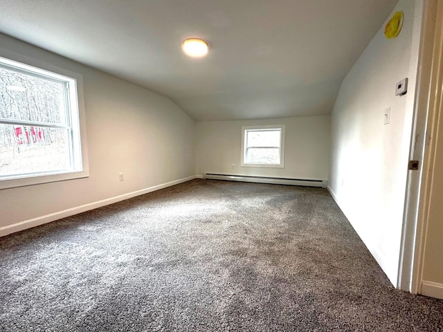 bonus room featuring a baseboard heating unit, carpet floors, and lofted ceiling