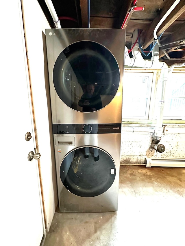 laundry area with stacked washer and dryer