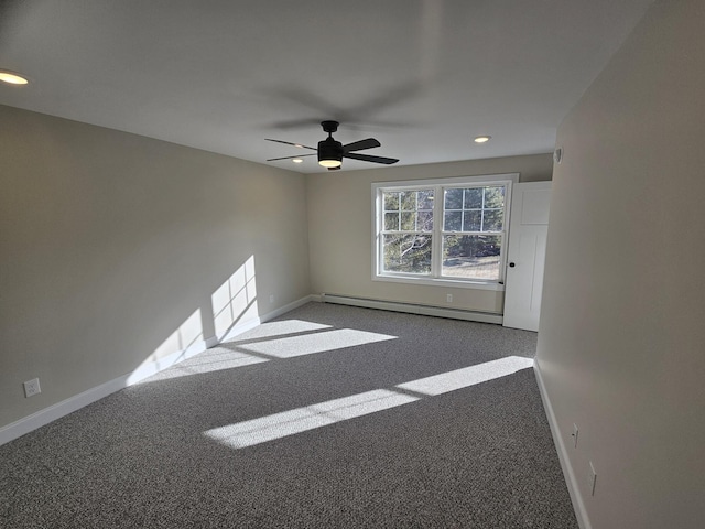 empty room featuring baseboard heating, ceiling fan, and carpet