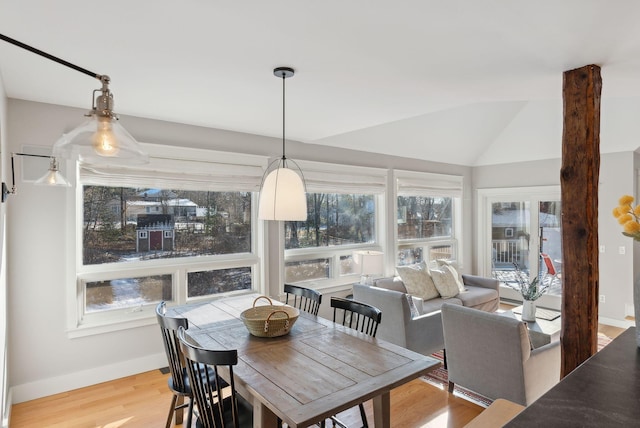 sunroom featuring vaulted ceiling