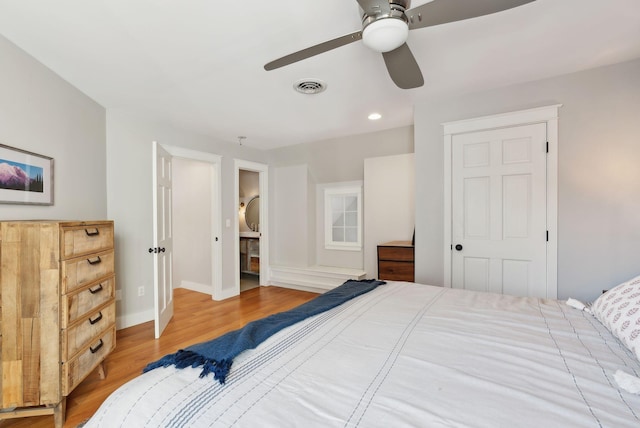 bedroom featuring ceiling fan, a closet, and light hardwood / wood-style flooring