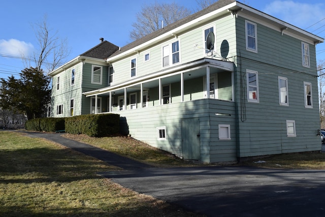 exterior space featuring a yard and covered porch