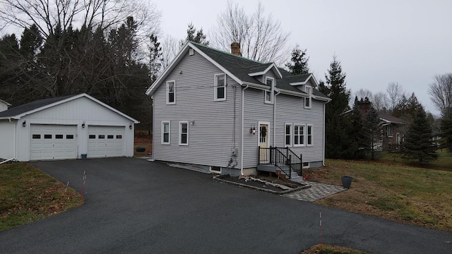 view of front facade with an outbuilding and a garage