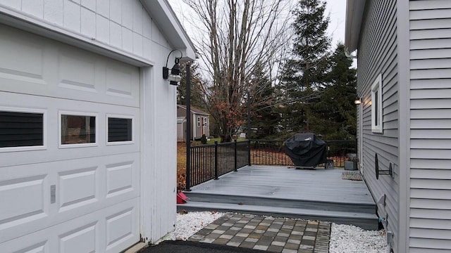 wooden deck featuring a grill